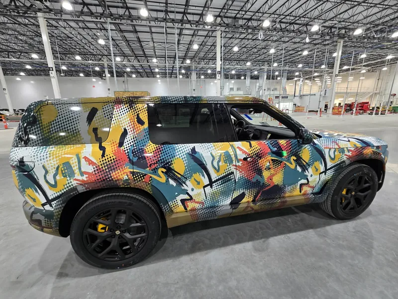 Rivian R2S launch art wrap in halftone graffiti print installed by Chicago Fleet Wraps