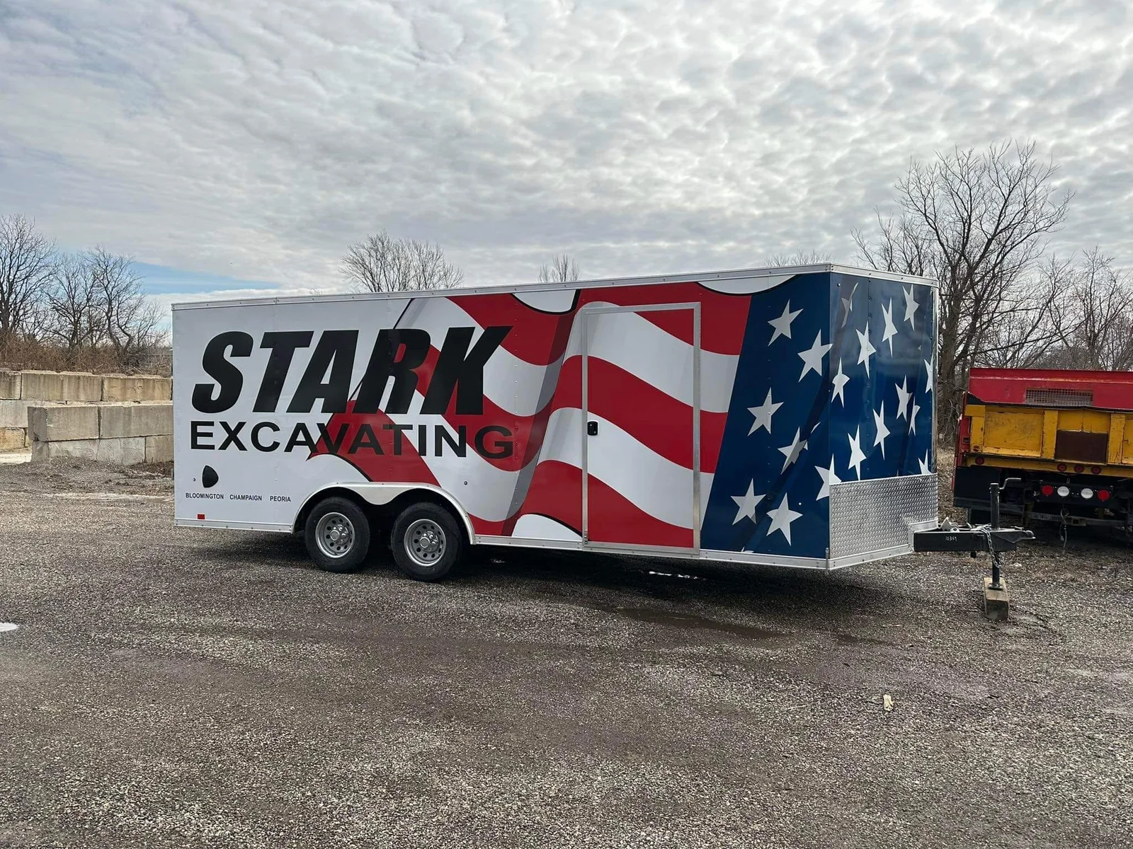 Stark Excavating trailer wrap — white driver side with red and blue rear flag design